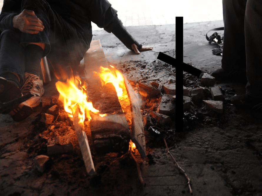 Needy men around fire with Nauthiz Rune